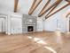 Spacious living room featuring stone fireplace, beamed ceiling and hardwood floors at 1575 Eastbrook Dr, Sarasota, FL 34231