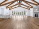 Bright and airy living room with wood floors, a fireplace, and large windows overlooking the backyard pool at 1575 Eastbrook Dr, Sarasota, FL 34231