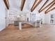 Bright open-concept living area featuring kitchen, hardwood floors and exposed beam ceilings at 1575 Eastbrook Dr, Sarasota, FL 34231
