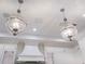 Stylish pendant lights accent custom cabinetry and a modern range hood at 1575 Eastbrook Dr, Sarasota, FL 34231