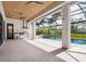 A stunning screened outdoor pool area with a summer kitchen and stainless-steel grill at 1575 Eastbrook Dr, Sarasota, FL 34231