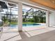 Stunning screened-in pool with outdoor kitchen, waterfall feature and view of landscaped backyard at 1575 Eastbrook Dr, Sarasota, FL 34231