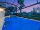 Beautiful pool with a screened enclosure and lush landscaping; great for entertaining or relaxing at 1575 Eastbrook Dr, Sarasota, FL 34231