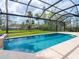 A screened pool offers stunning water views and privacy at 1575 Eastbrook Dr, Sarasota, FL 34231
