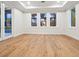 Well-lit room with three large windows, providing ample natural light and views of the backyard at 1575 Eastbrook Dr, Sarasota, FL 34231