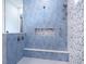 Blue tiled shower with a built in seat and niche at 1575 Eastbrook Dr, Sarasota, FL 34231
