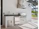 A stainless-steel grill, refrigerator, and sink complete a modern outdoor summer kitchen at 1575 Eastbrook Dr, Sarasota, FL 34231