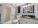 The bathroom features a dark granite sink and a shower with floral curtains at 1711 Southwood St # 1711, Sarasota, FL 34231