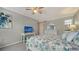 Bedroom featuring a TV, floral bedding, and stylish white furniture, creating a cozy and inviting space at 1711 Southwood St # 1711, Sarasota, FL 34231