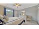 Serene bedroom with a bed and an accent chair with natural light and soft colors at 1711 Southwood St # 1711, Sarasota, FL 34231