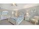 Bright bedroom with floral bedding, complemented by a ceiling fan and stylish white furniture at 1711 Southwood St # 1711, Sarasota, FL 34231