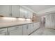 This kitchen features granite counters, white cabinets, and stainless steel hardware and fixtures at 1711 Southwood St # 1711, Sarasota, FL 34231