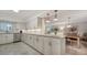 Bright kitchen with granite countertops, stainless steel appliances, and white cabinets overlooking dining area at 1711 Southwood St # 1711, Sarasota, FL 34231