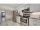 Well-lit kitchen featuring stainless steel appliances, white cabinets, and stylish countertops at 1711 Southwood St # 1711, Sarasota, FL 34231