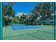 The tennis court is lined with lush greenery and offers a secluded play area at 1711 Southwood St # 1711, Sarasota, FL 34231