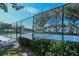 The tennis court is lined with lush greenery and offers a secluded play area at 1711 Southwood St # 1711, Sarasota, FL 34231