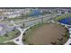 Aerial view of the community soccer field, pond, sidewalks, and residential homes at 177 Tierra Verde Way, Bradenton, FL 34212