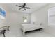 Bright bedroom with white walls, tiled floor, ceiling fan, and natural light from the window at 177 Tierra Verde Way, Bradenton, FL 34212