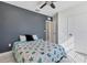 Comfortable bedroom with a sea themed quilt, gray accent wall, and natural light from window at 177 Tierra Verde Way, Bradenton, FL 34212