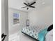 Cozy bedroom with white walls, tiled floor, ceiling fan, and bright natural light at 177 Tierra Verde Way, Bradenton, FL 34212