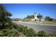 Welcoming community entrance with a charming bell tower, lush landscaping, and a well-maintained roadway at 177 Tierra Verde Way, Bradenton, FL 34212