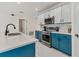 Bright kitchen boasts white cabinets, mosaic backsplash, stainless appliances, and blue accent island at 177 Tierra Verde Way, Bradenton, FL 34212