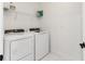 Bright laundry room with a full-sized, modern washer and dryer and practical shelving at 177 Tierra Verde Way, Bradenton, FL 34212