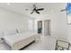 Bright bedroom with neutral tones, tile flooring, and en-suite bathroom at 177 Tierra Verde Way, Bradenton, FL 34212