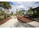 Community playground with shaded play area, slide, picnic tables and walking path at 177 Tierra Verde Way, Bradenton, FL 34212