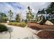 Community playground features a shaded play area, slide, bench seating, and walking path at 177 Tierra Verde Way, Bradenton, FL 34212