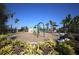 Community playground with swings and climbing area surrounded by lush landscaping and beautiful palm trees at 177 Tierra Verde Way, Bradenton, FL 34212
