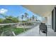 Balcony with a lovely view, relaxing outdoor furniture, and plenty of natural light in a comfortable setting at 1800 Benjamin Franklin Dr # B208, Sarasota, FL 34236