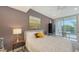 This bedroom features a desk, balcony, cool toned paint and fan and lots of natural light at 1800 Benjamin Franklin Dr # B208, Sarasota, FL 34236