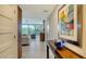 Hallway with a view of an open living space offering bright natural light and gorgeous flooring and decorative art at 1800 Benjamin Franklin Dr # B208, Sarasota, FL 34236