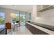Modern kitchen boasts high-end appliances, spacious countertops, and sliding glass doors at 1800 Benjamin Franklin Dr # B208, Sarasota, FL 34236