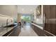 Sleek, modern kitchen featuring high-end appliances, spacious counter tops, and outdoor views at 1800 Benjamin Franklin Dr # B208, Sarasota, FL 34236