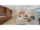 Bright living room with modern marble floors, neutral furniture, and access to an outdoor balcony at 1800 Benjamin Franklin Dr # B208, Sarasota, FL 34236