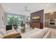 A stunning living room with amazing decor, comfortable furniture, an outdoor view, and access to dining and kitchen at 1800 Benjamin Franklin Dr # B208, Sarasota, FL 34236