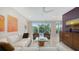 Open living room with comfortable furniture, a decorative table, amazing artwork, and a great outdoor view at 1800 Benjamin Franklin Dr # B208, Sarasota, FL 34236