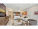 A bright living room has white sectional, modern furniture, and elegant marble floors throughout at 1800 Benjamin Franklin Dr # B208, Sarasota, FL 34236
