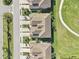 Overhead view of townhomes featuring tan roofs, green lawns, and symmetrical landscaping at 18117 Gawthrop Dr # 101, Lakewood Ranch, FL 34211
