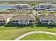 Serene aerial view of condos surrounded by a golf course and waterfront in a well-kept neighborhood at 18117 Gawthrop Dr # 101, Lakewood Ranch, FL 34211