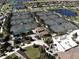 Overhead shot of community tennis courts and amenity center with lush landscaping and nearby parking area at 18117 Gawthrop Dr # 101, Lakewood Ranch, FL 34211