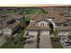 Aerial view of homes with two-car garages near a golf course with ponds and lush greenery at 18117 Gawthrop Dr # 101, Lakewood Ranch, FL 34211