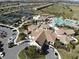 Aerial view of clubhouse with pool, tennis courts, and tropical landscaping at 18117 Gawthrop Dr # 101, Lakewood Ranch, FL 34211