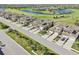 Aerial view of homes featuring tan roofs near a golf course with ponds and lush greenery at 18117 Gawthrop Dr # 101, Lakewood Ranch, FL 34211