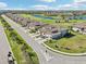 Aerial view of a lovely neighborhood with a lush green golf course and scenic ponds at 18117 Gawthrop Dr # 101, Lakewood Ranch, FL 34211