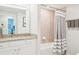 Bright bathroom featuring granite countertops, framed mirror, and a shower-tub combo with neutral tiling at 18117 Gawthrop Dr # 101, Lakewood Ranch, FL 34211