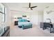 Spacious bedroom with a ceiling fan, desk, sitting area and large window providing ample light at 18117 Gawthrop Dr # 101, Lakewood Ranch, FL 34211