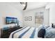 Clean, well-lit bedroom with a ceiling fan, television, framed wall art, and a comfortable bed at 18117 Gawthrop Dr # 101, Lakewood Ranch, FL 34211